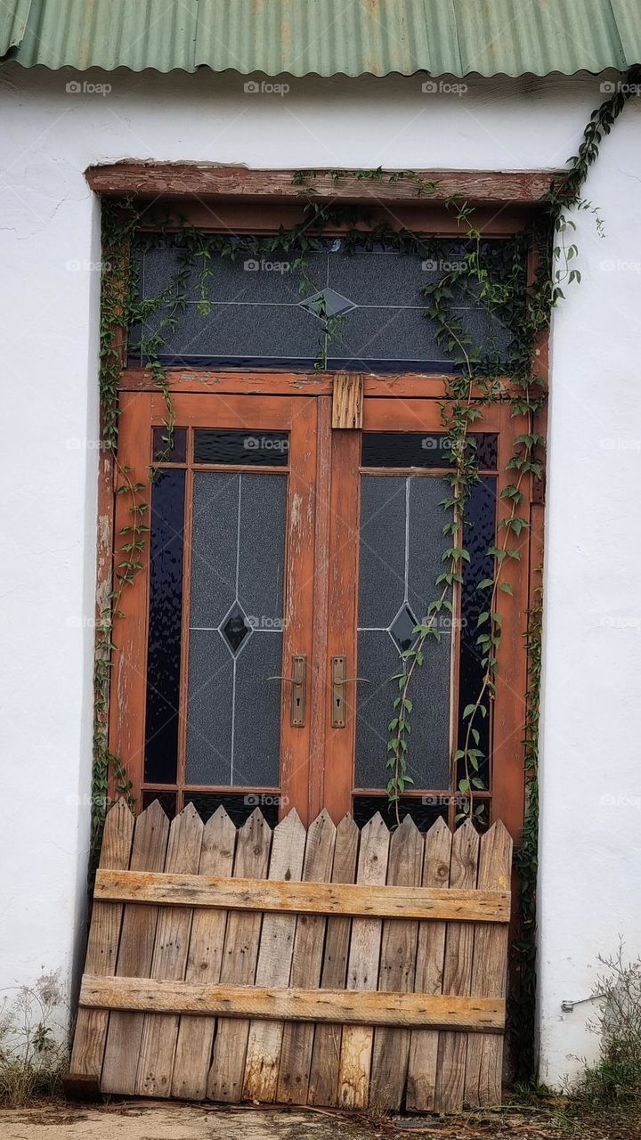 glass and wooden door of a abandoned homestead