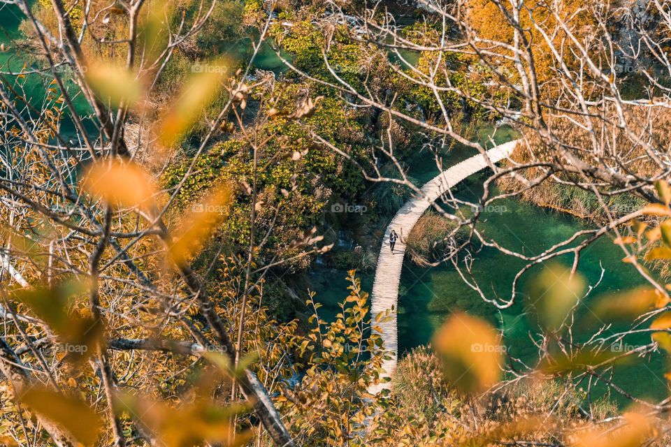 Wooden pathway across lake at Plitvice lakes national park in Croatia in autumn