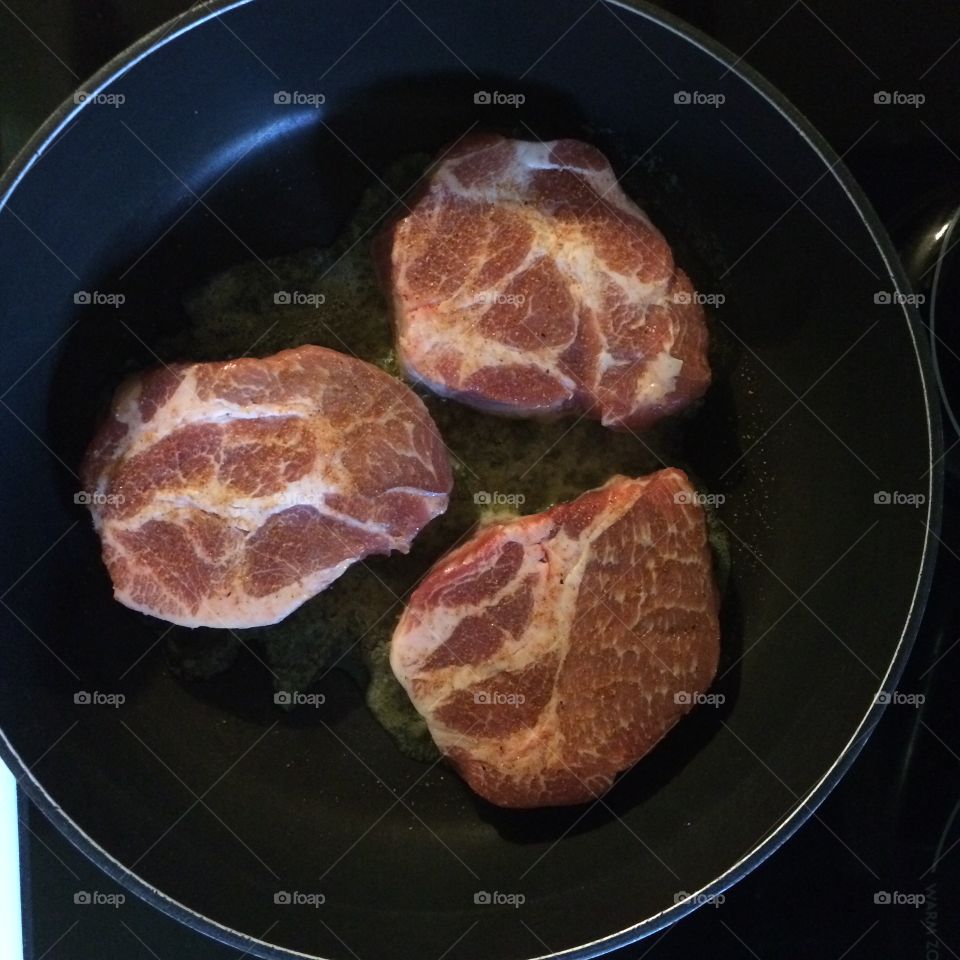 Pork chops in the pan with garlic butter
