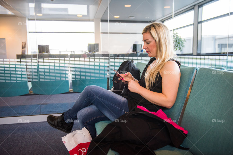 Woman waiting for her flight at Copenhagen Airport.