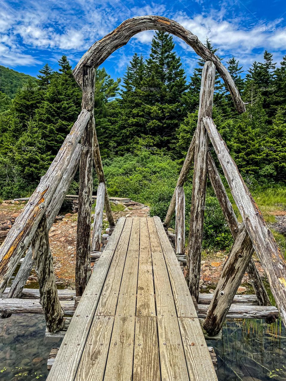 “Rustic Bridge.”  A footbridge of logs and timbers spans a small creek by Jordan Pond in Acadia.