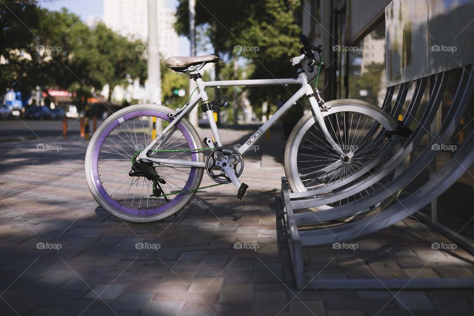 Locked bicycle at bicycle parking . Transport, storage and safety concept .