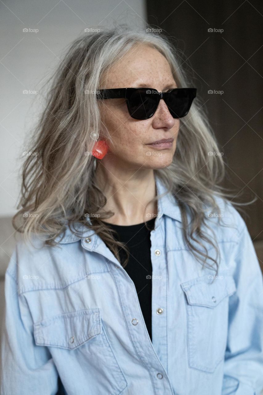 Stylish mature model wearing sunglasses