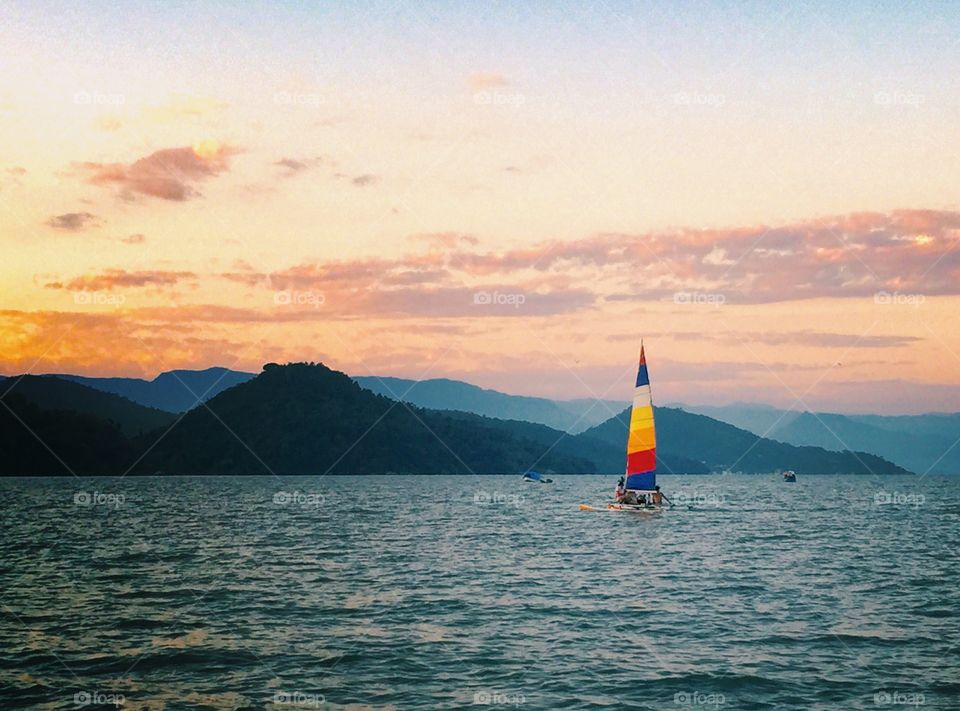 The colored sailboat . In Paraty a lonely and colored sailboat. 