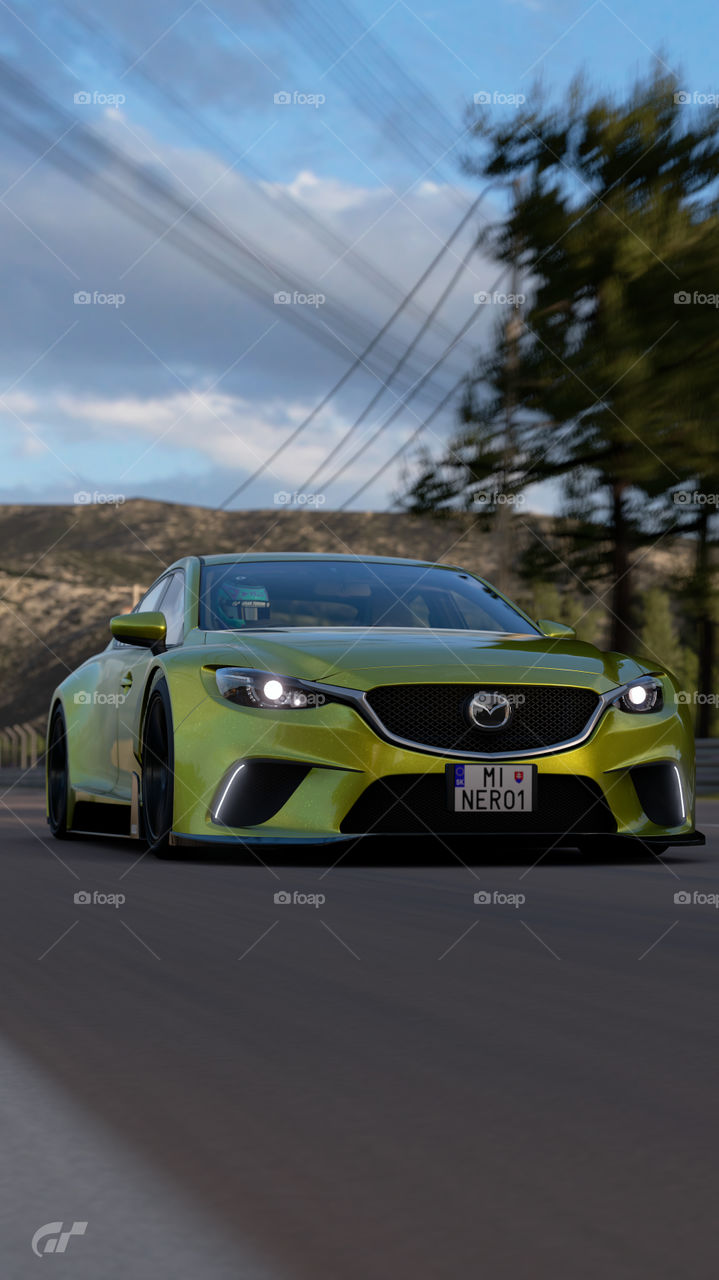 Yellow wide body kit Race modified Mazda 6 ( Atenza ) skyactive going fast on countryside road in the morning 