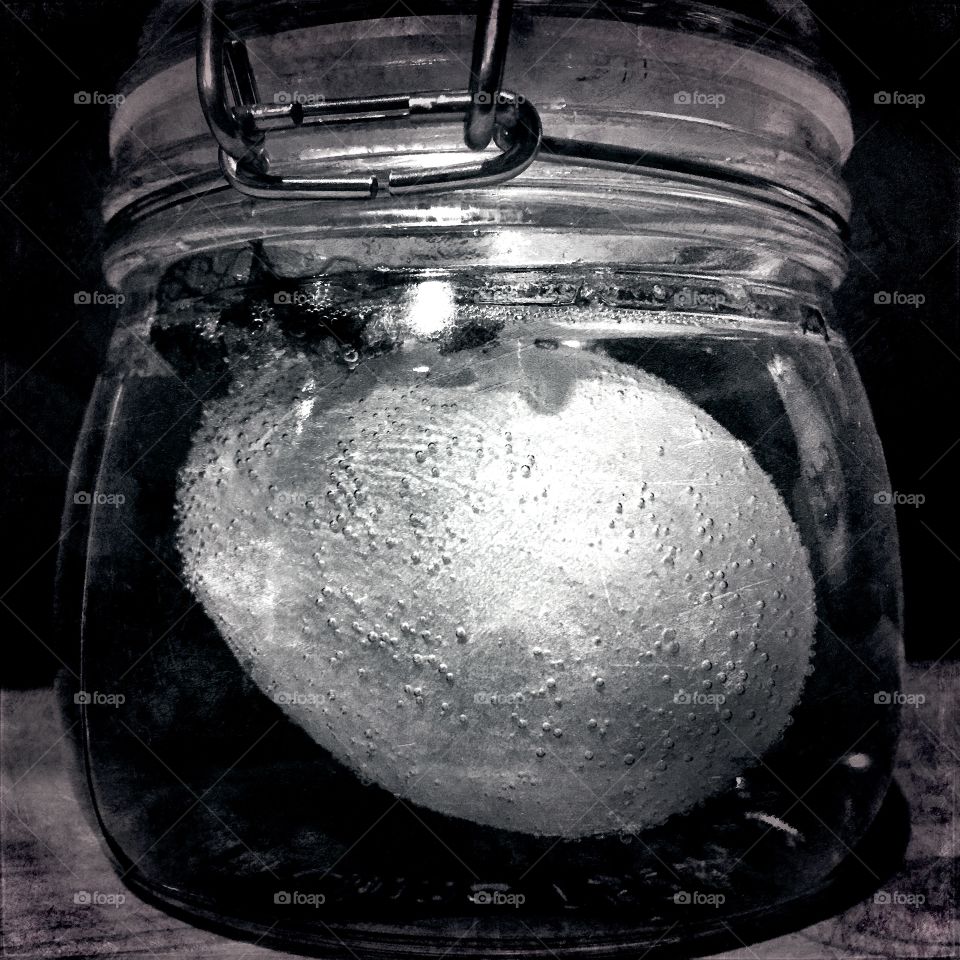 Bubbles on a submerged egg. Scientific experiment for children - porosity of eggshells