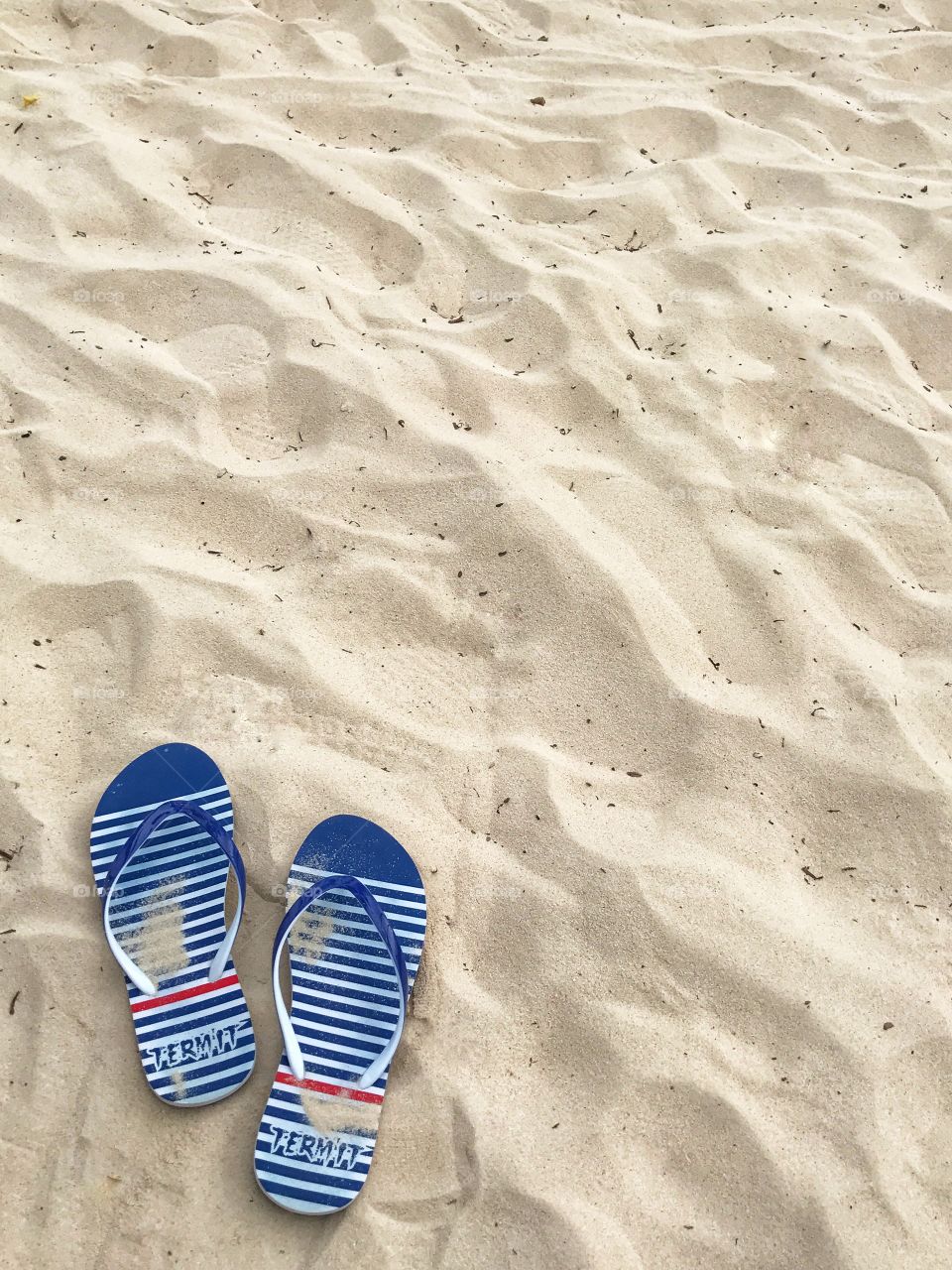 Flip flops on sand beach