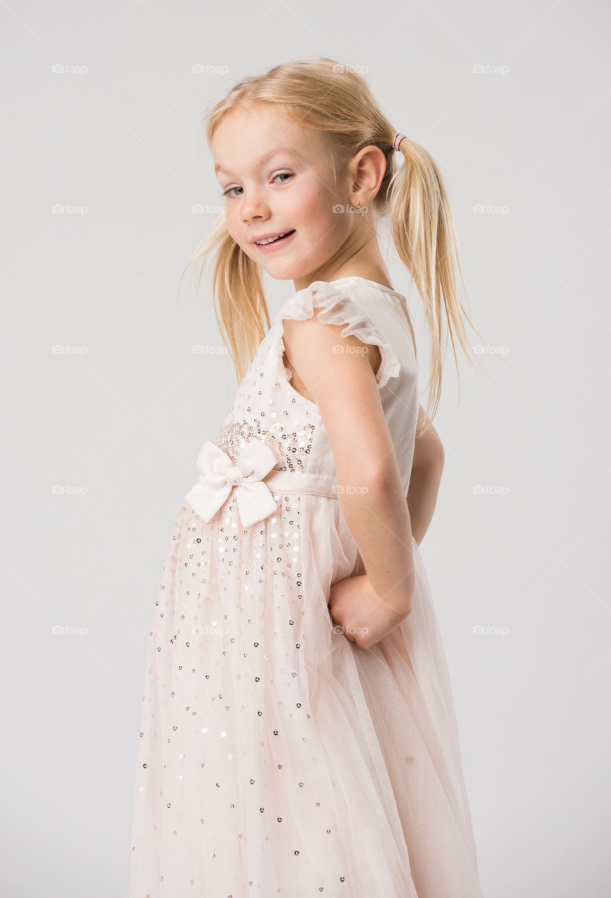 6 year old child model posing in a studio.