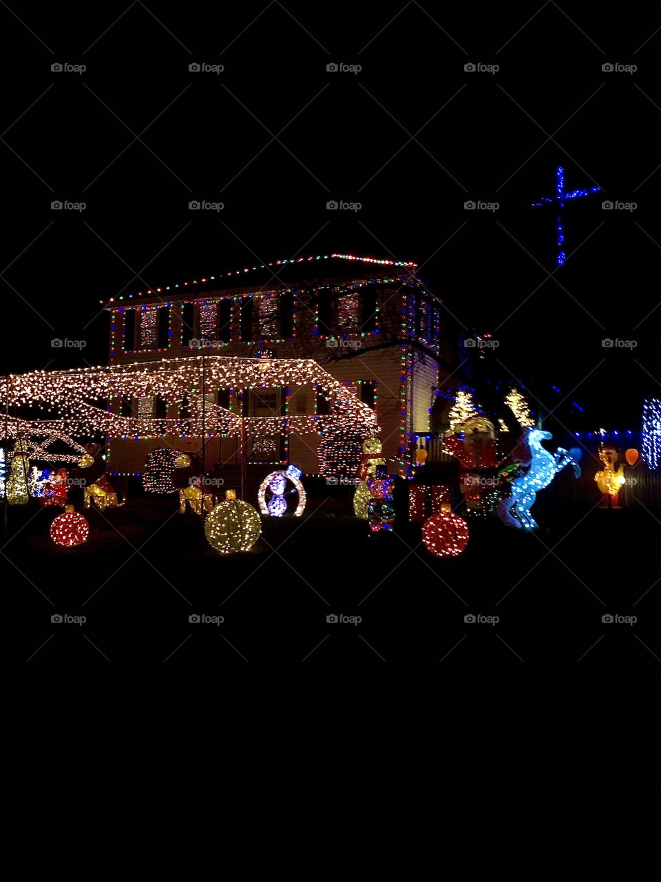 House decorated with colorful Christmas Lights and festive holiday decor.
