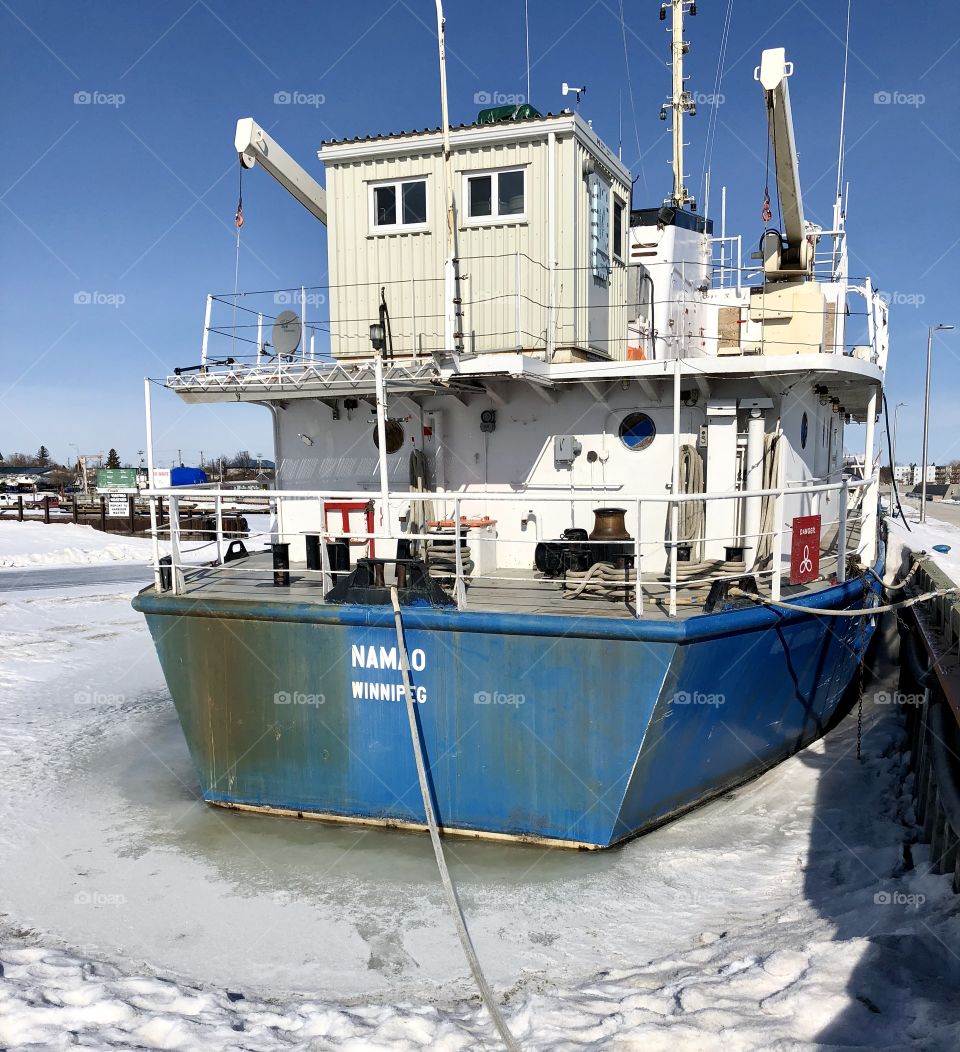 Old boat frozen into the lake