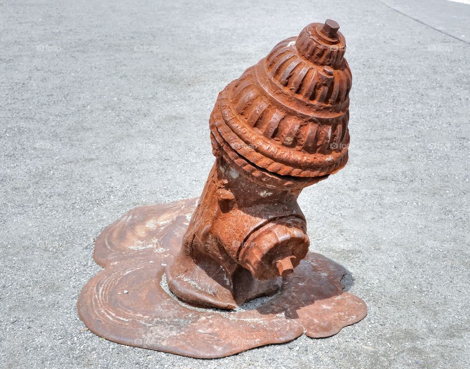 Rusty Melted Hydrant. A rusty and melted iron water hydrant on display on Governor's Island. Interesting art captured by Fleetphoto. 