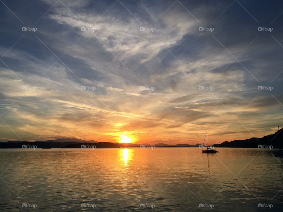 Orange, glowing sunset on a beautiful night boating in the Gulf Islands, British Columbia, Canada