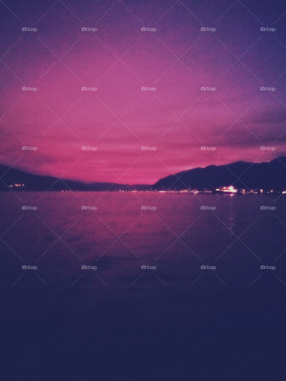 amazing pink sunset, sea, city and mountains