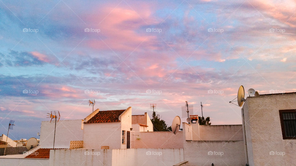 Antenas, satellite dishes, rooftops and evening sky in Spain