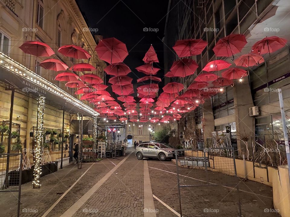 Belgrade red umbrella street city centre by night