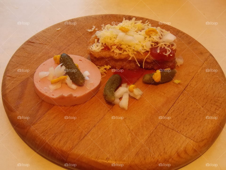 bread wrapped in egg , cheese, onion, pickle, ketchup, mustard, meat