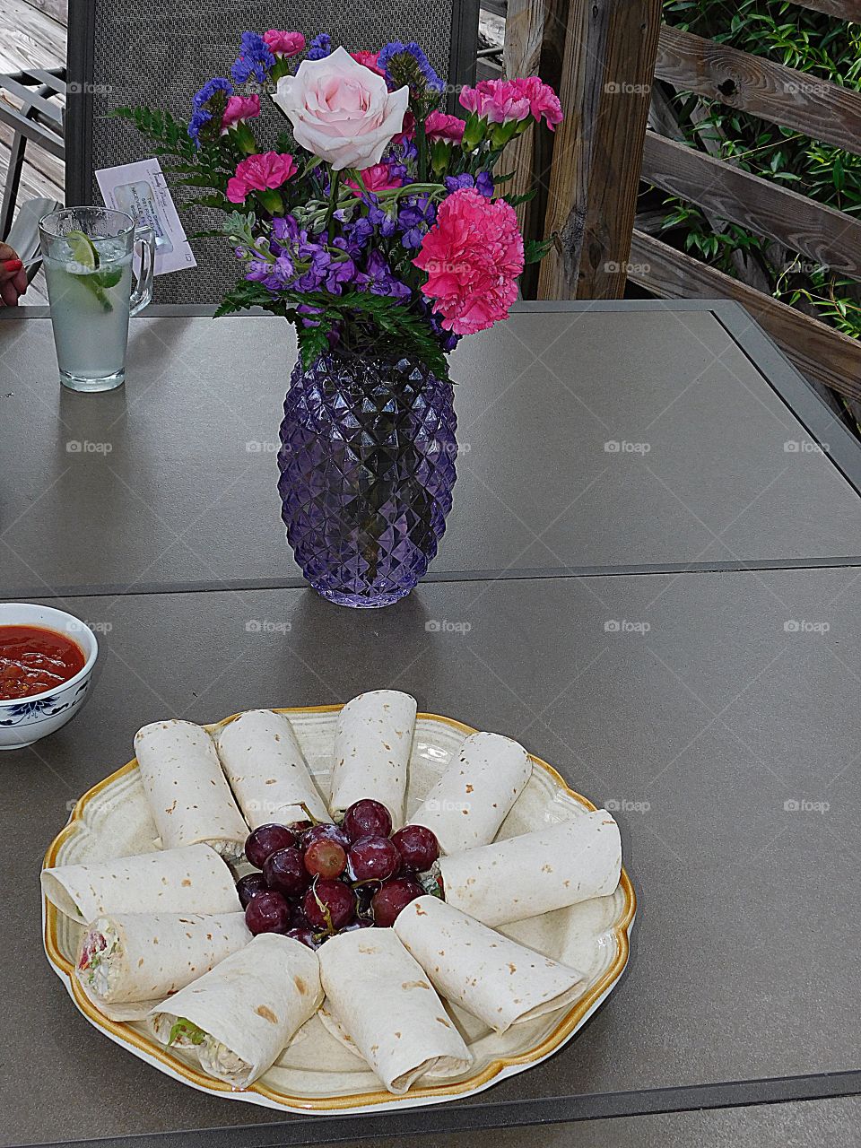 My favorite sandwich - chicken salad, sauce and tantalizing grapes with a vase full of flowers