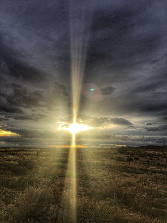 The sun is peeking from behind the clouds just before sunset nearby Capitol Reef National Park. 