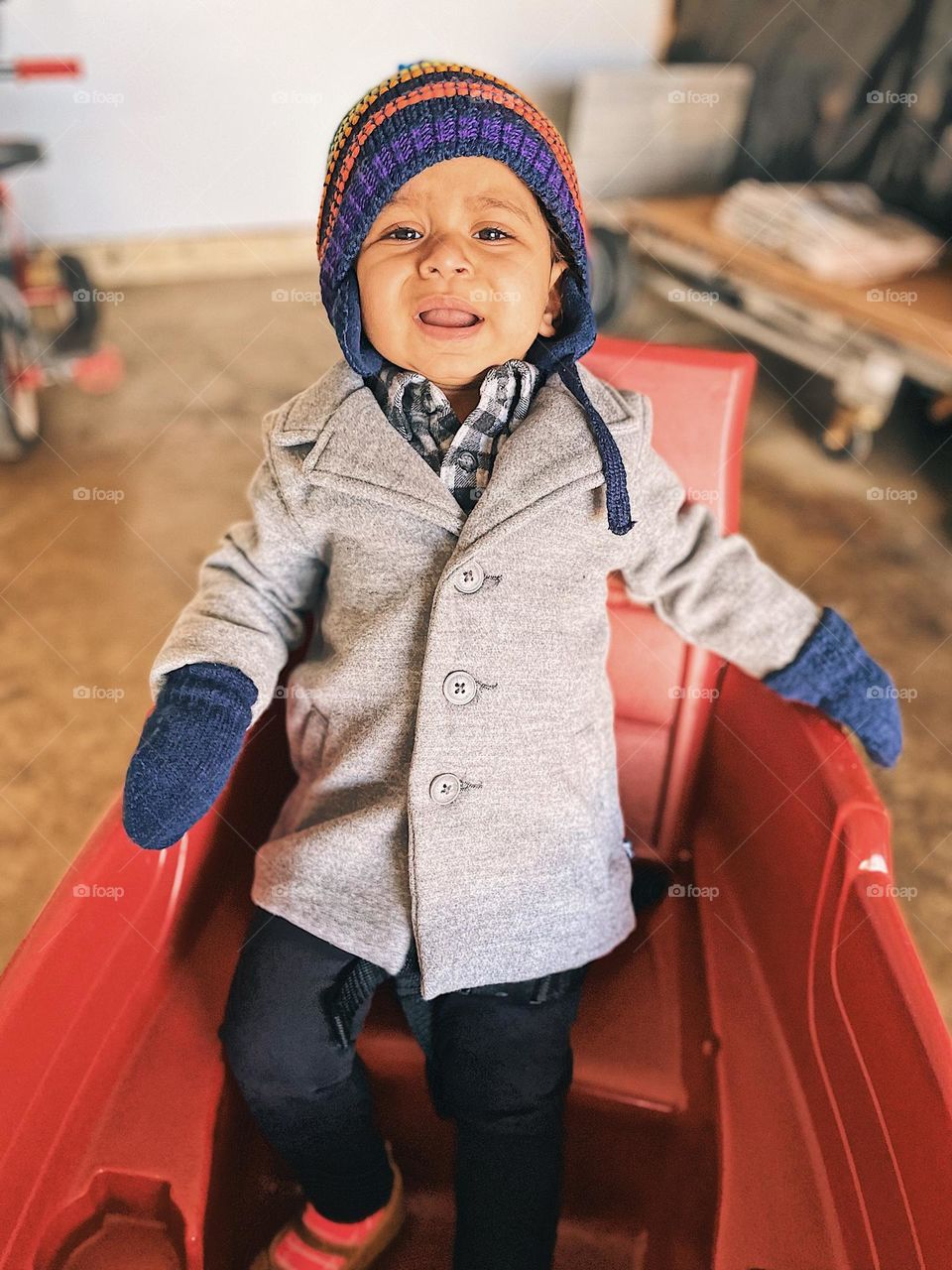 Upset toddler in Radio Flyer wagon, toddler is sad, toddler showing emotion of sadness, toddler is unhappy in red wagon, toddler cries out with sadness, facial expressions on a toddler, making sad faces in a Radio Flyer wagon, crying out with sadness
