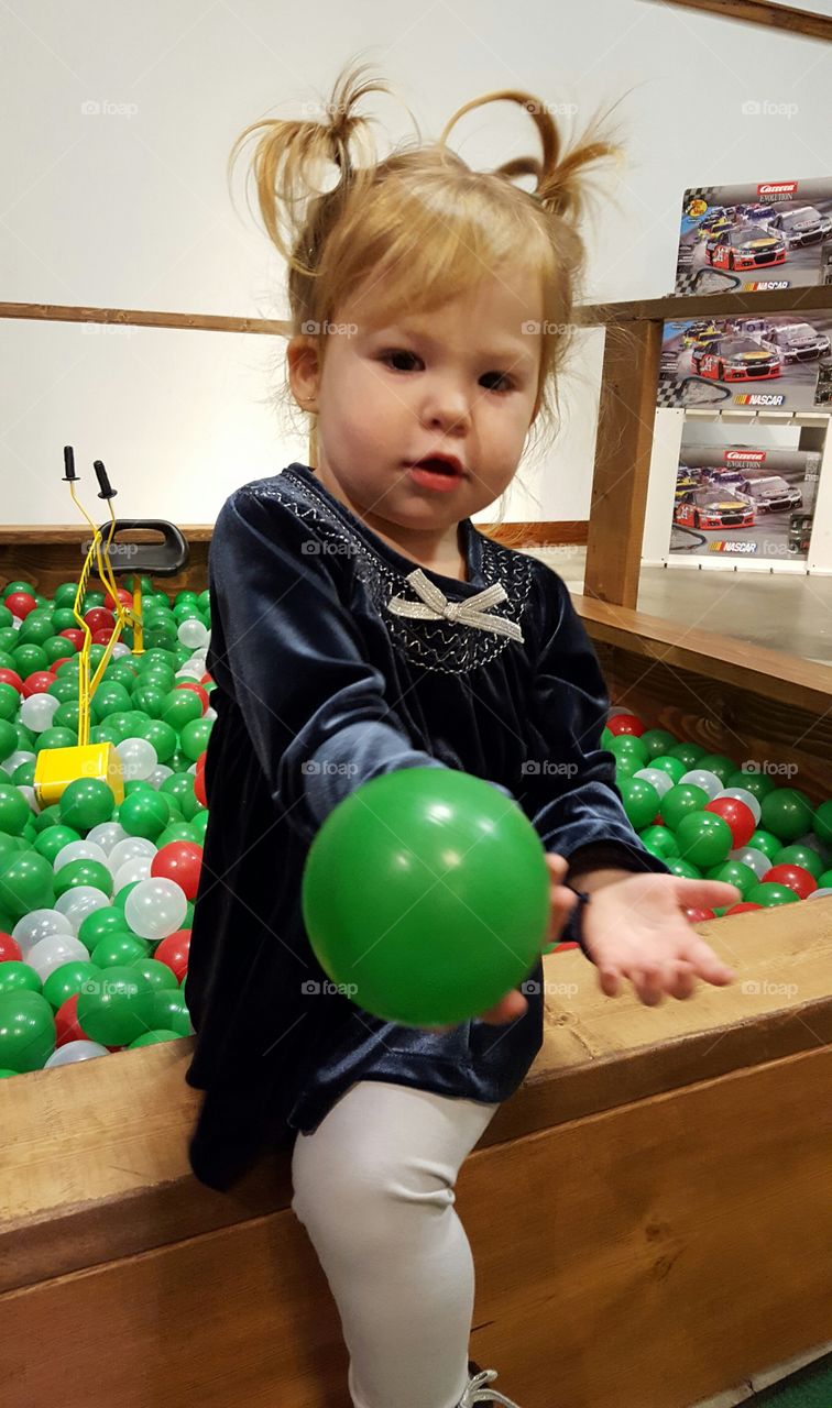 Portrait of cute girl holding green ball