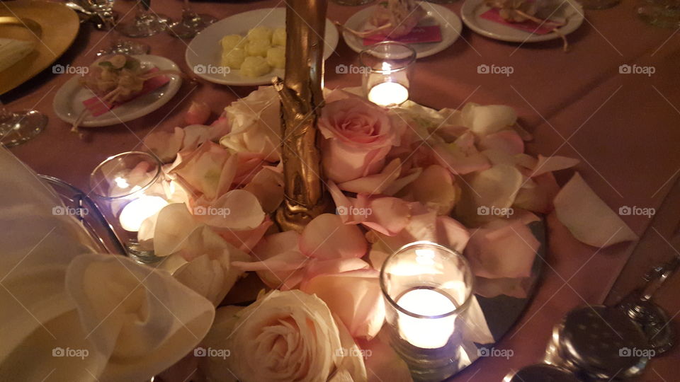 candles and rosepetals on a pink table