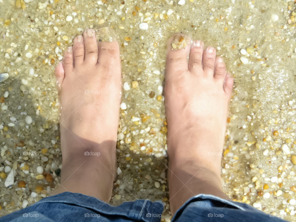 Feet In The Sand On The Beach