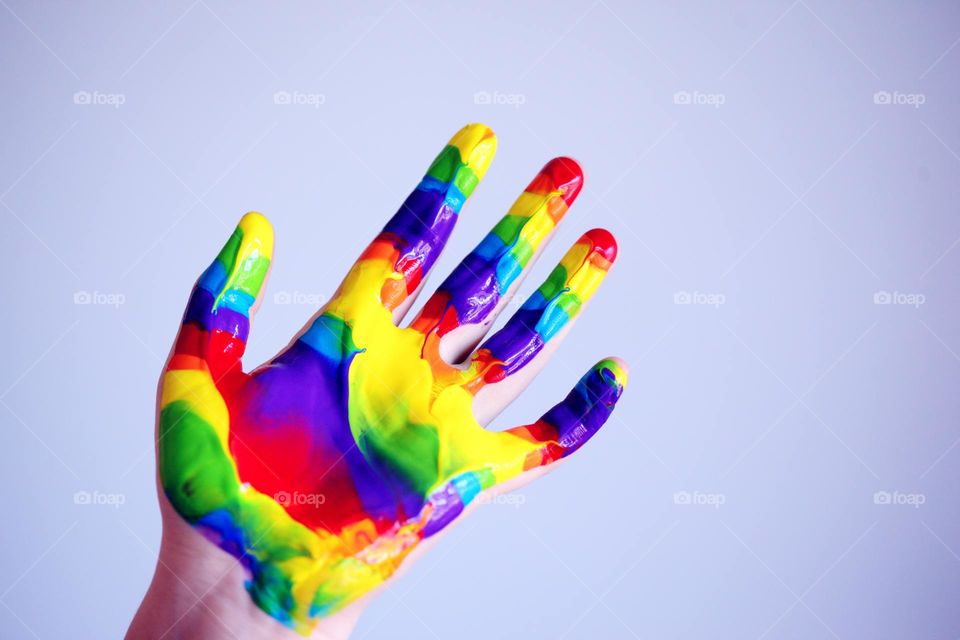 brightly painted hand, artistic photo very colorful