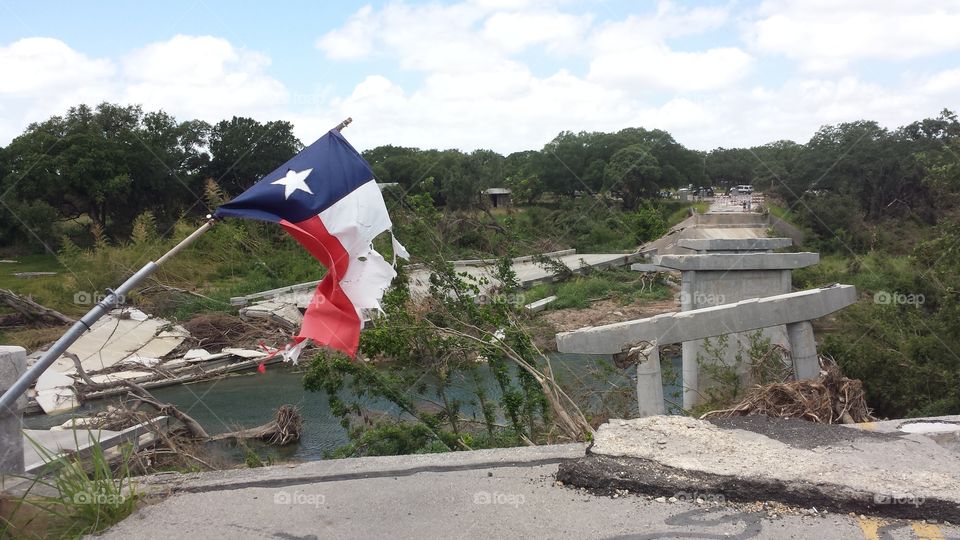 hope. texas flag flying over the washed out fisher store bridge after the memorial day flooding in Wimberley
