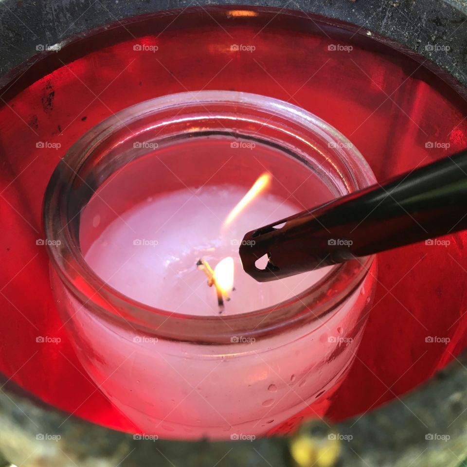 Red vigil candle being lit.