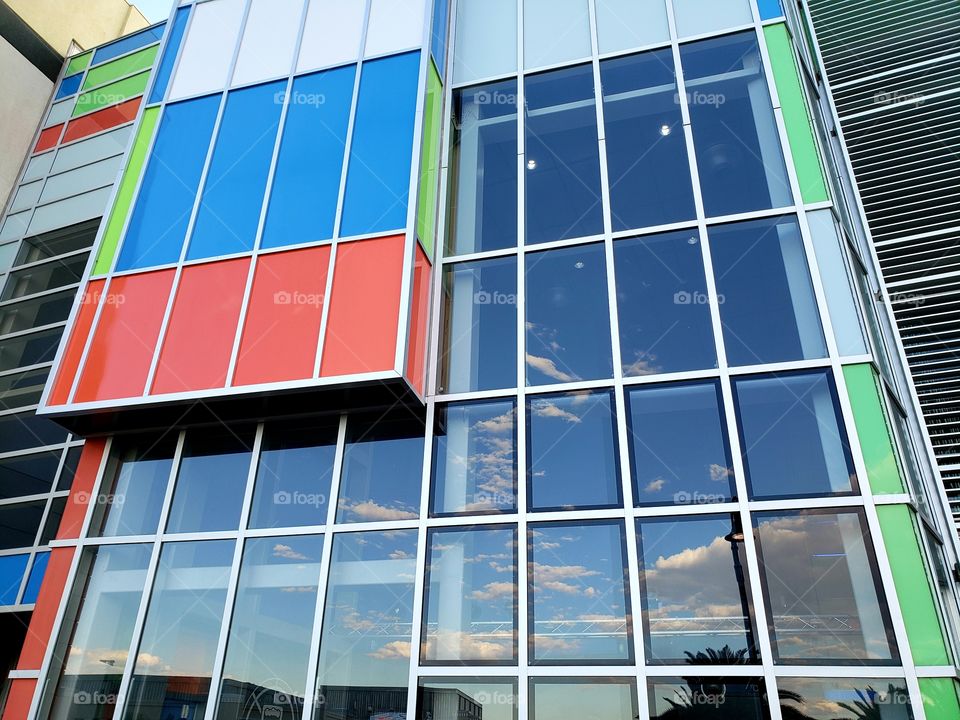 glass building windows reflect the sky