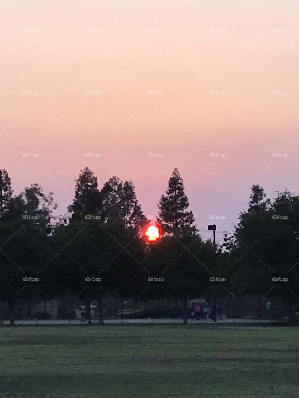 Sunset. The neighborhood park looks beautiful and peaceful as the radiant sun descends for the evening. A marvelous sight for sore eyes indeed.