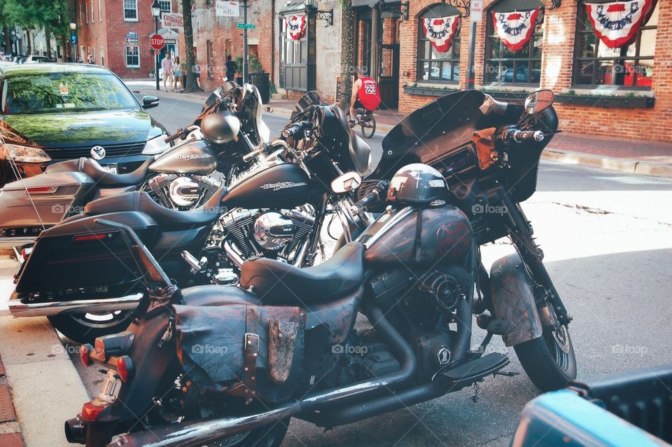 Motorcycles parked on Main Street with flag bunting in the background