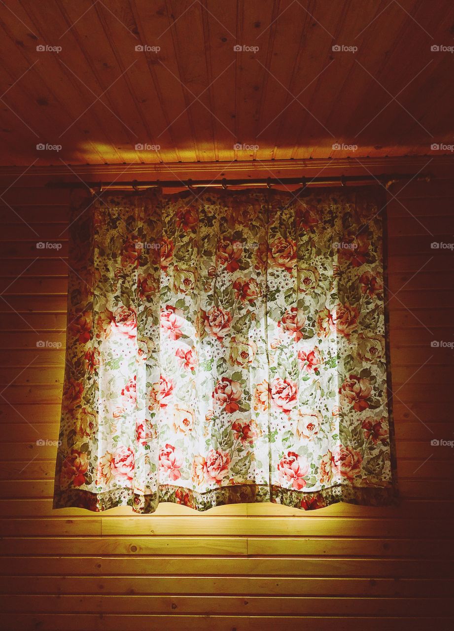 Sunlight over the Curtains at the wooden wall 