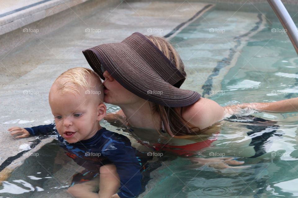 Mom and child having fun at the pool 