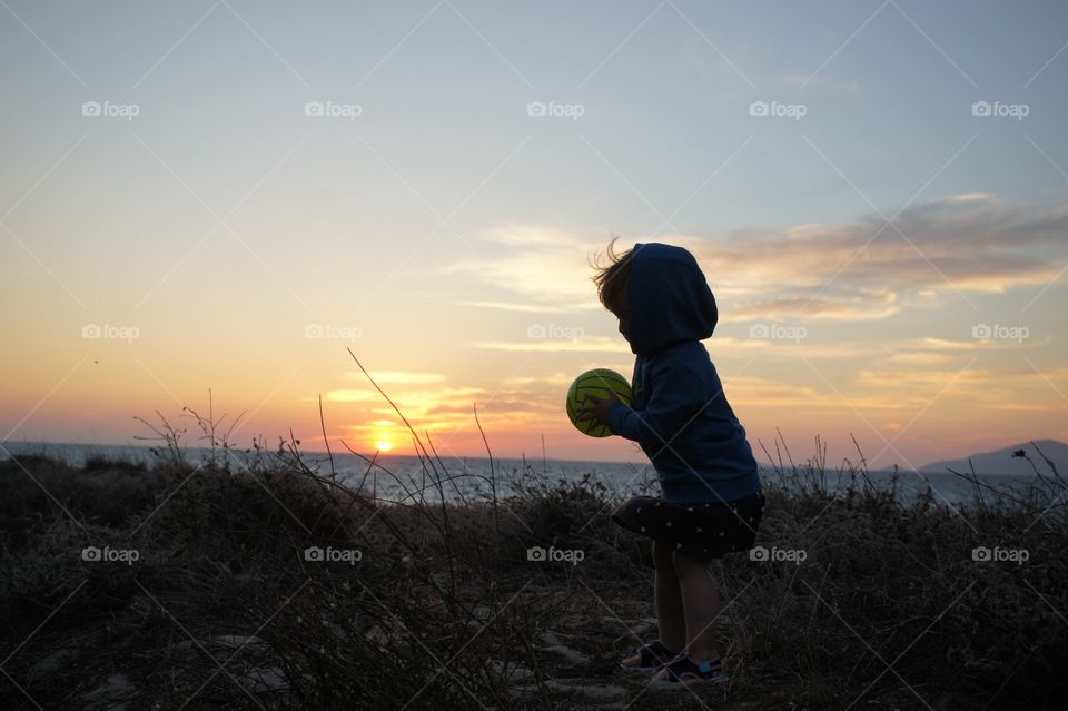 playing games on the sunset near the beach