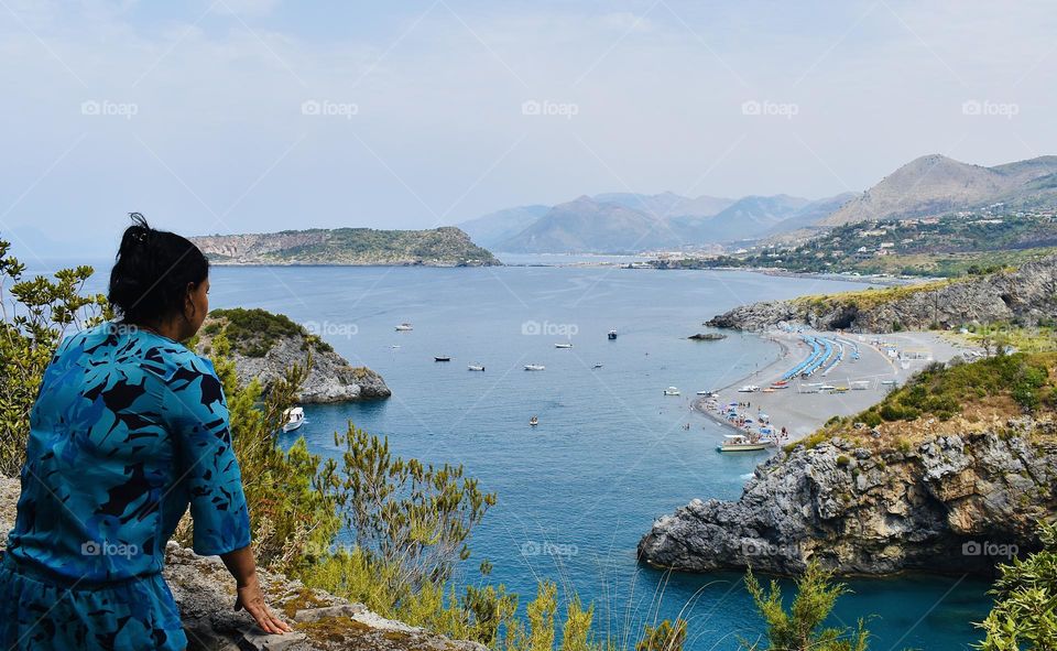 Woman enjoying seaside view in summer 