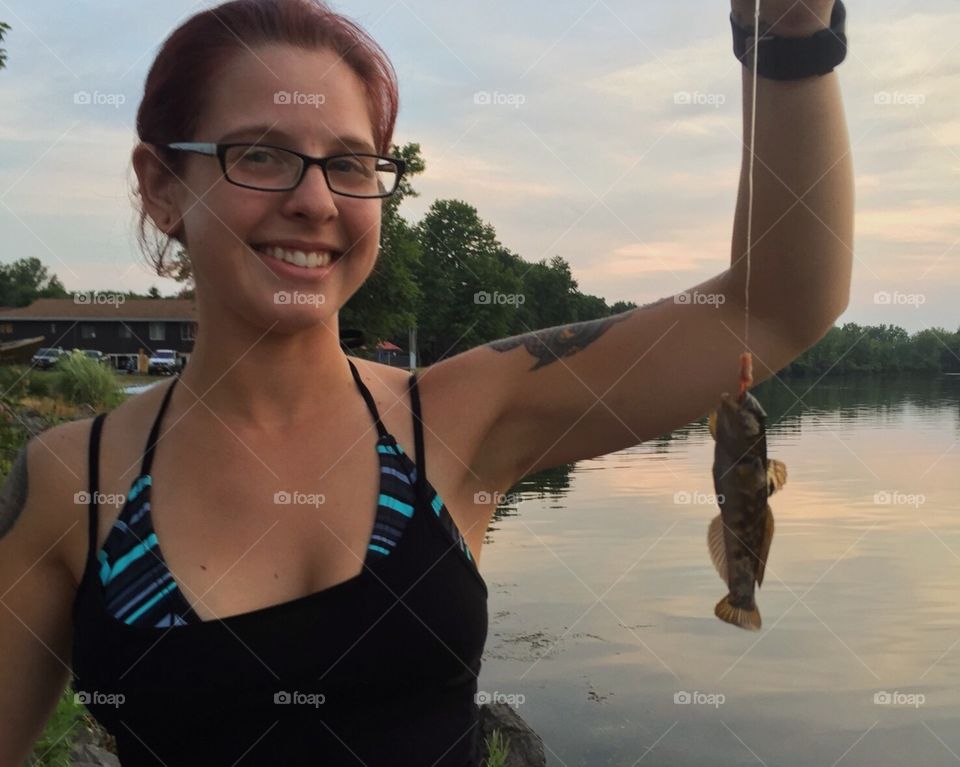Beautiful woman holding fish in hand
