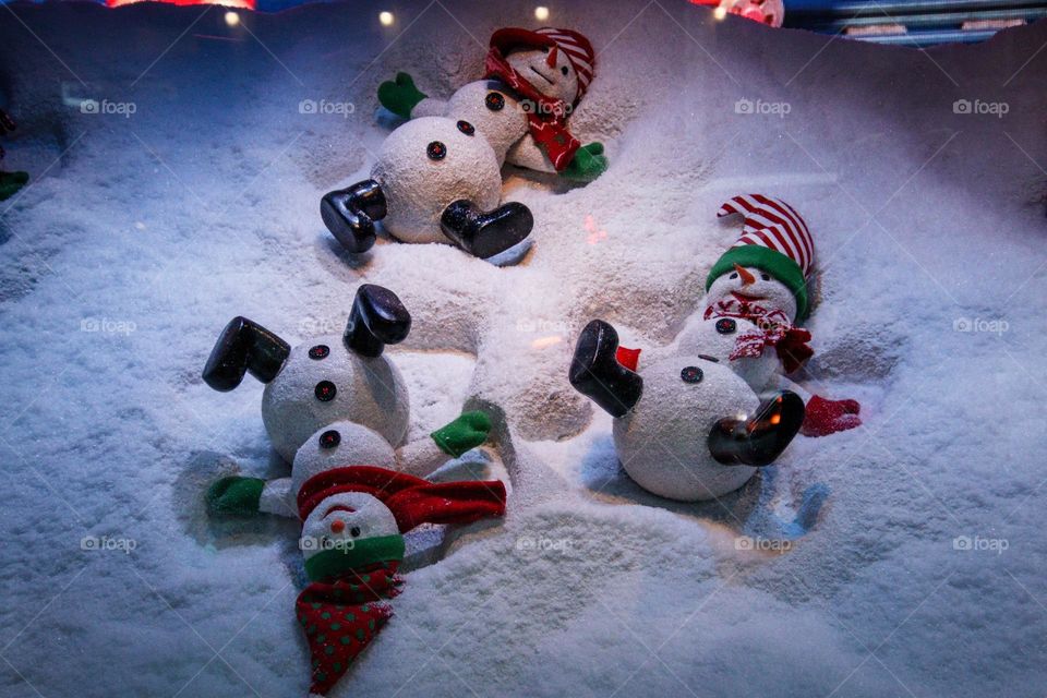 Snowmen are making snow angels