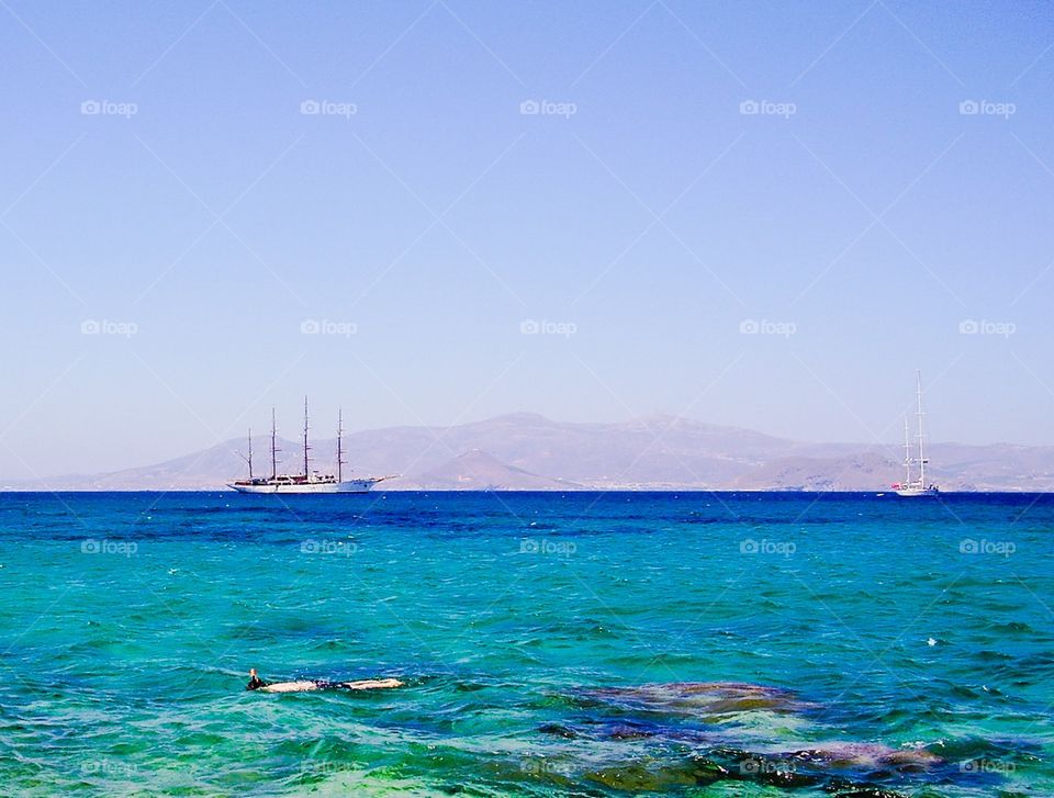 Let's go sailing in Greece. Sailing ships outside Naxos island Greece