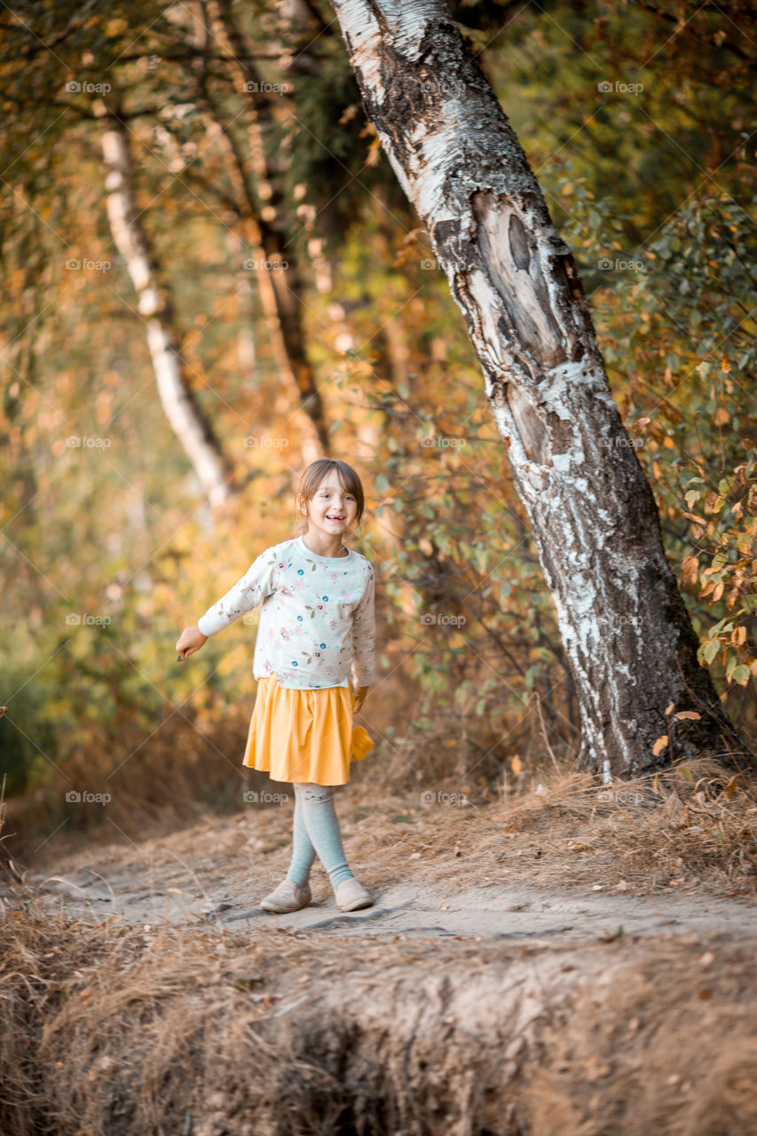 Little girl portrait at autumn day