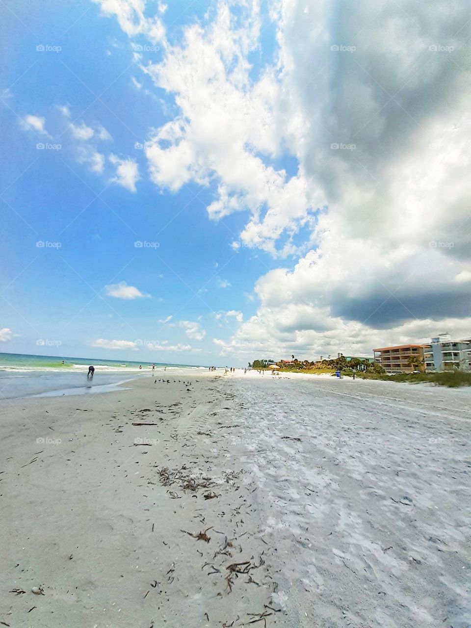 A beautiful landscape photo with blue sky and white clouds at Indian Rocks Beach in Tampa, Florida.