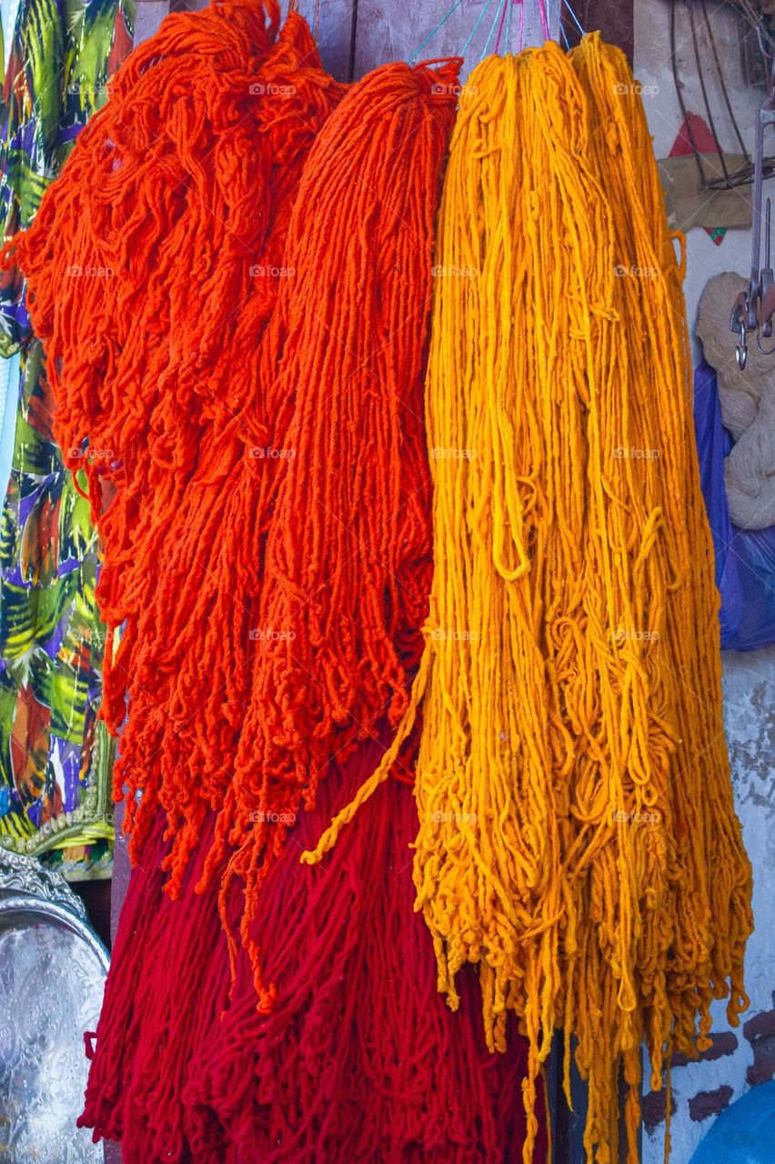 red orange and yellow strands of wool