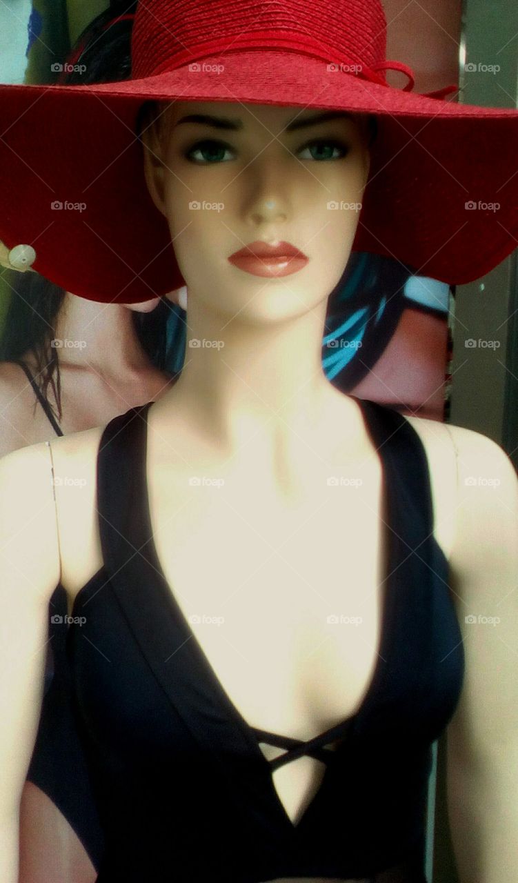 Beautiful gorgeous women mannequin
with black swinsuit and red hat