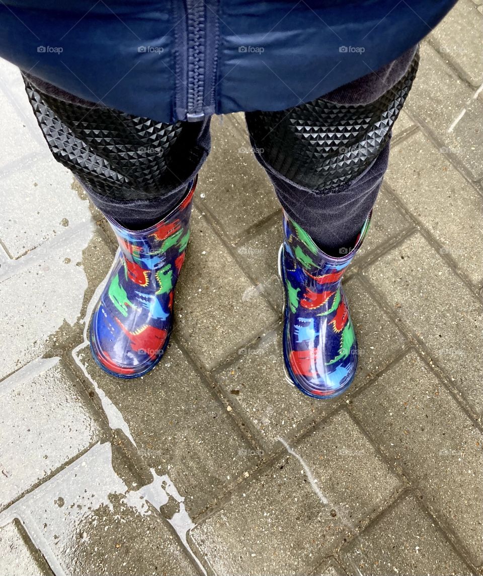 child in rubber boots