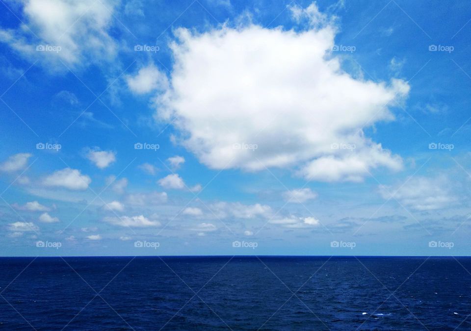 Cloudscape on the sea, close up of the beautiful cumulus in the blue sky.