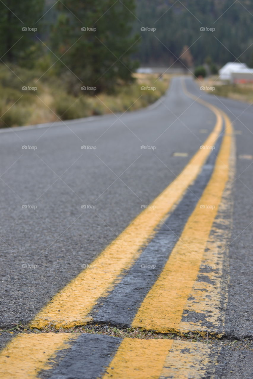 Close-up of road with yellow marking