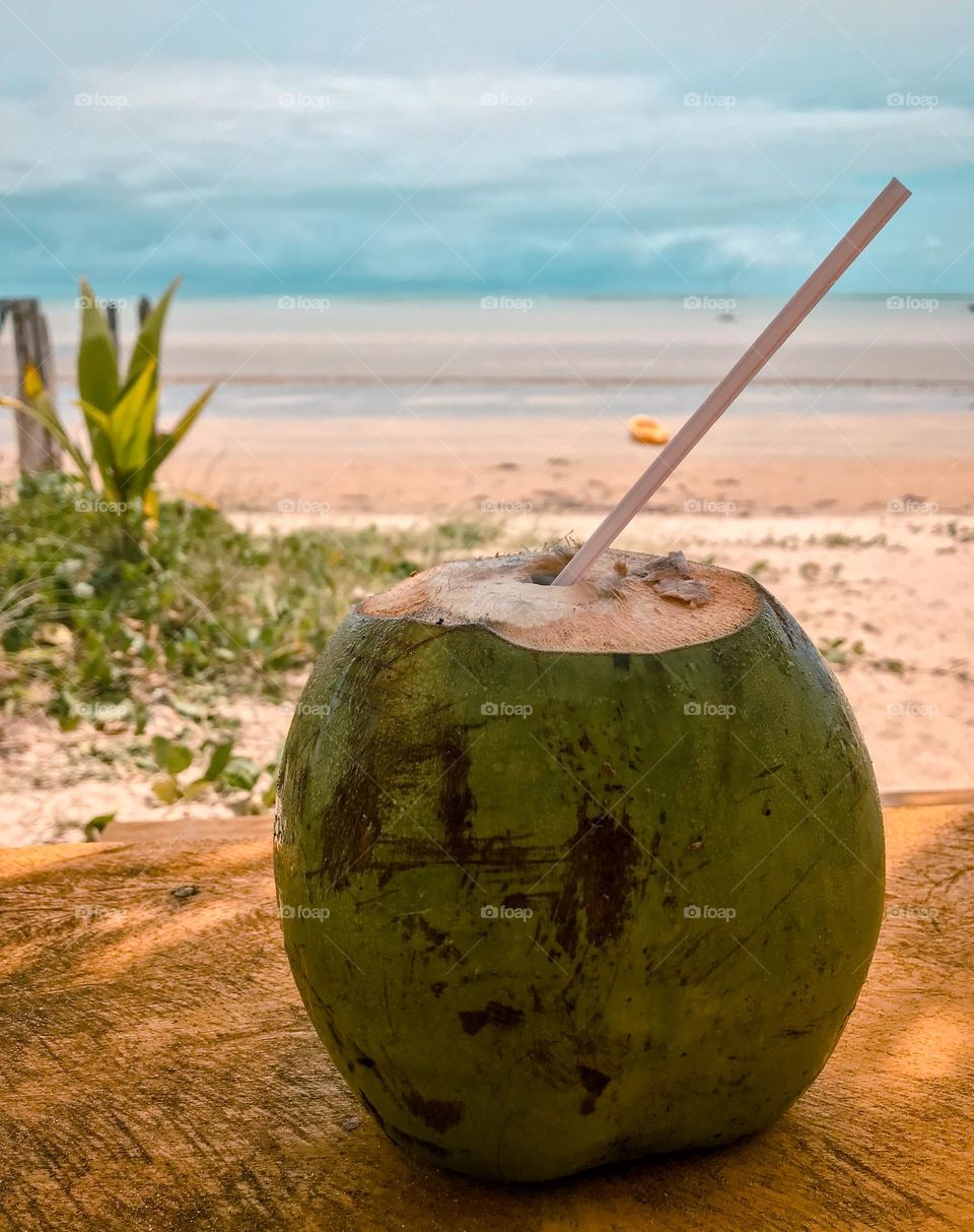 drinking coconut water and admiring the beautiful beach of cumuruxatiba bahia brazil