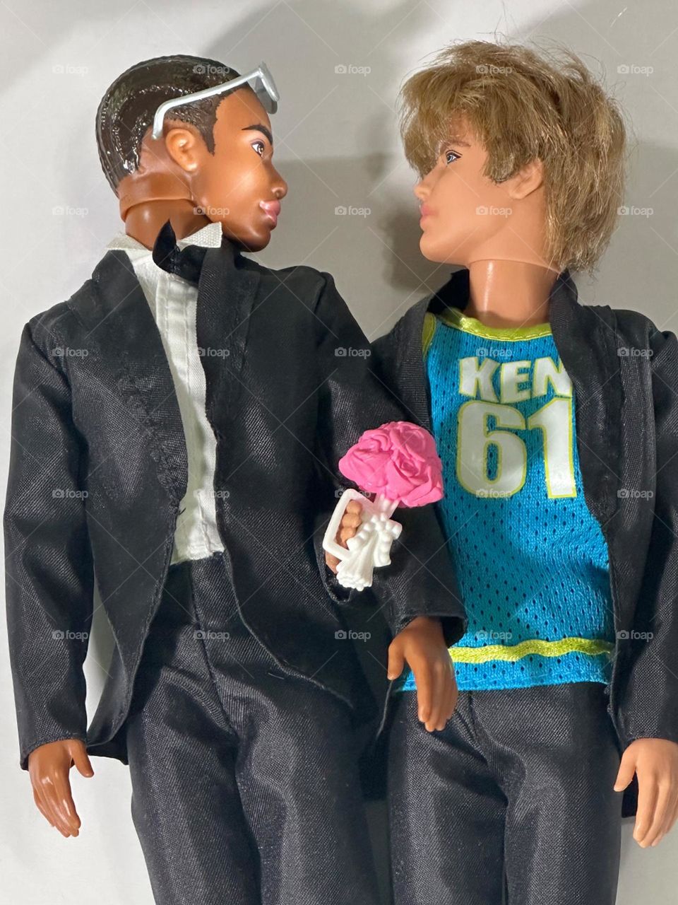 Ken turns 62 and finally marries the love of his life. No hard feelings from “just a friend” Barbie - she supplied the wedding bouquet. Two Ken dolls in tuxes (that irrepressible Ken is wearing his tank top) getting hitched