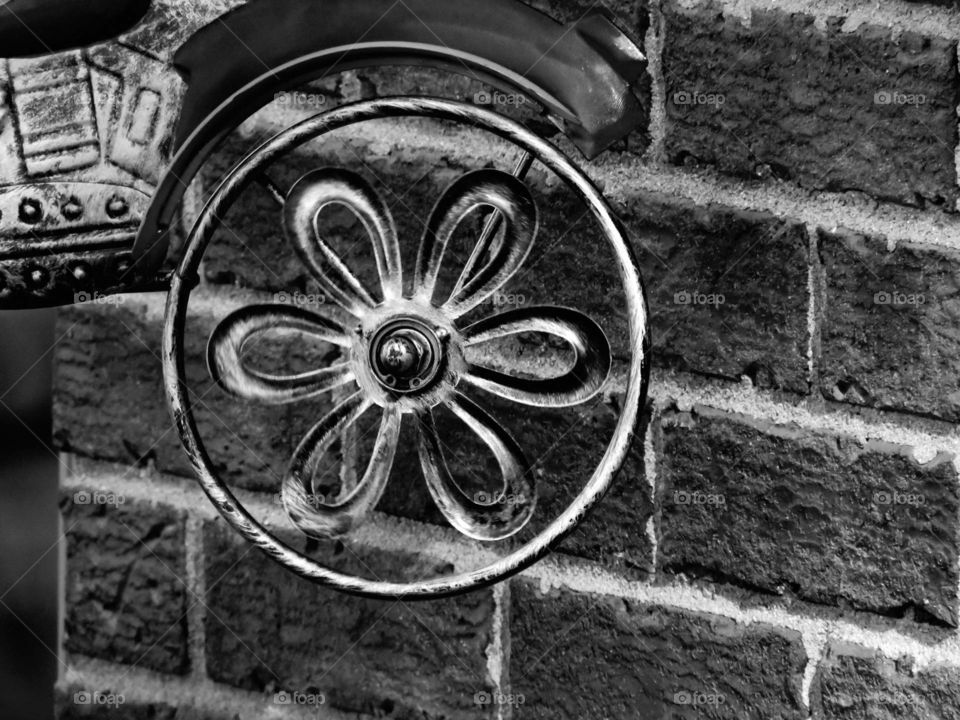 wheel against wall black and white