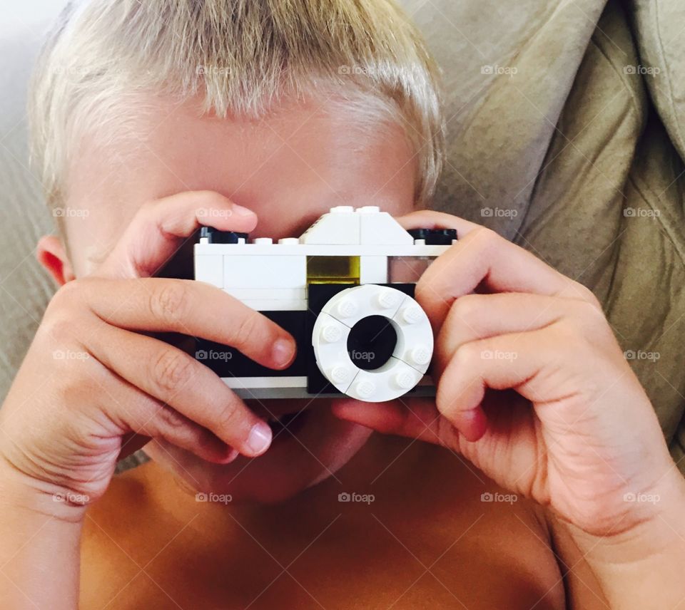 Snap . My son pretending to snap a photo with a Lego camera.